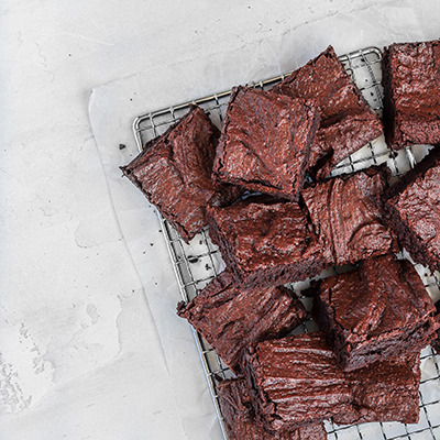 Brownies sliced and stacked on a cooling rack