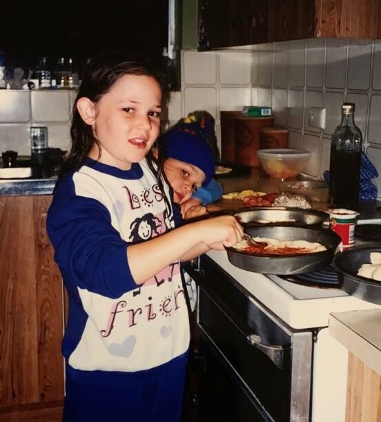 Caitlin Imogen at a young age making pizza