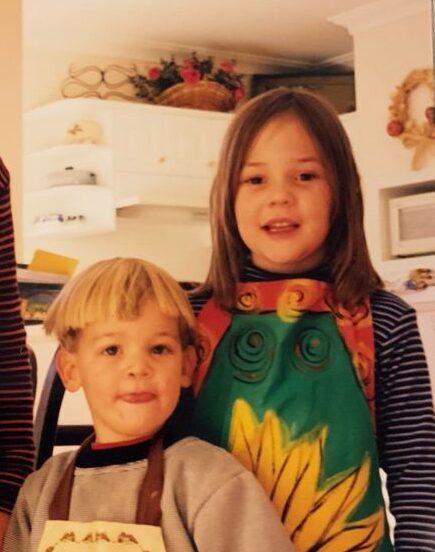 Caitlin Imogen at a young age with apron on