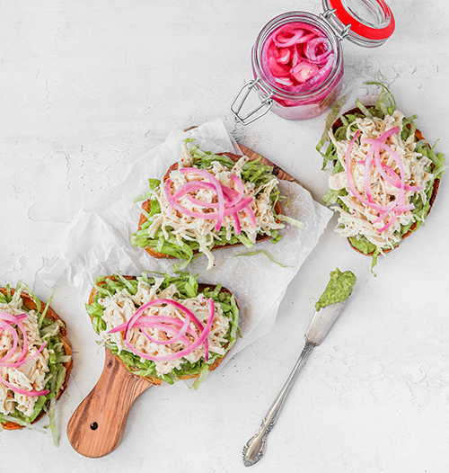 Open-faced chicken sandwiches on parchment paper