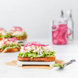 Open-faced chicken sandwich with pickled onions