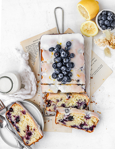 Lemon blueberry loaf cake sliced on paper