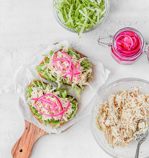 Pickled onions on open faced chicken sandwich