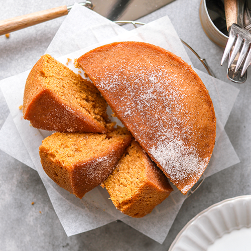 Pumpkin spice tea cake sliced on parchment paper