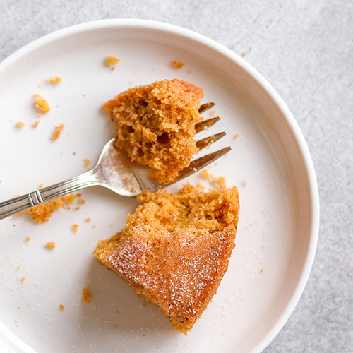 Pumpkin cake on a plate with a forkful taken out