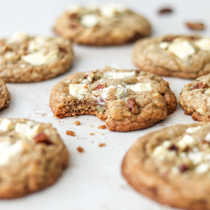 White chocolate chip pecan cookies with a bite taken out