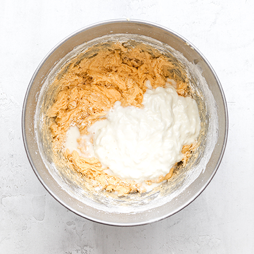 Flour partially mixed in and sour cream added to the mixing bowl