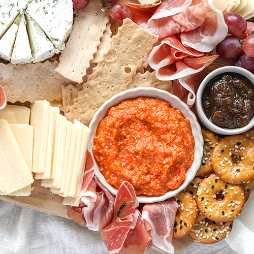 Pesto dip on a cheeseboard