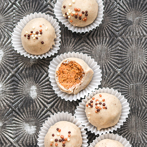 Truffles in cupcake liners on a patterned baking tray