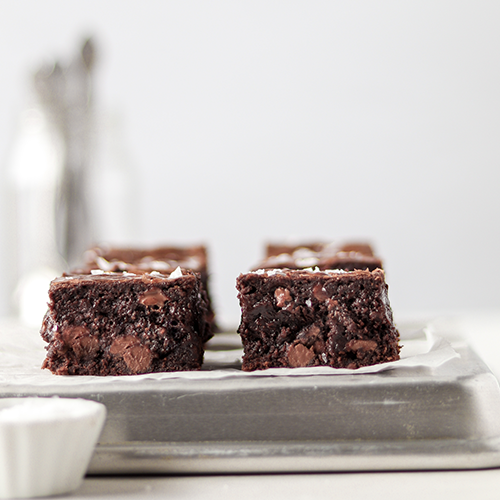 Perfectly lined homemade brownies on a silver baking tray