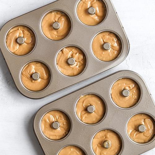 Donut batter in two mini donut baking trays